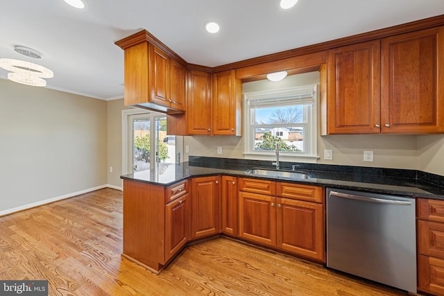 kitchen featuring dishwasher, light hardwood / wood-style flooring, a healthy amount of sunlight, and sink