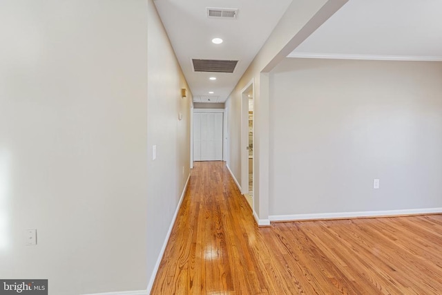 corridor with light hardwood / wood-style floors