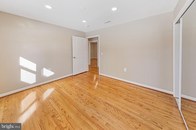 unfurnished bedroom featuring a closet and light hardwood / wood-style flooring