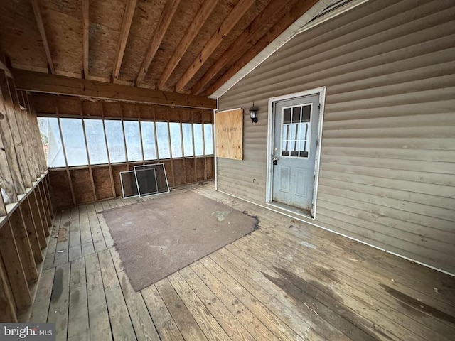 unfurnished sunroom with lofted ceiling