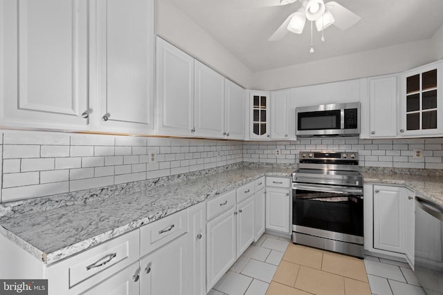 kitchen featuring appliances with stainless steel finishes, white cabinetry, and ceiling fan