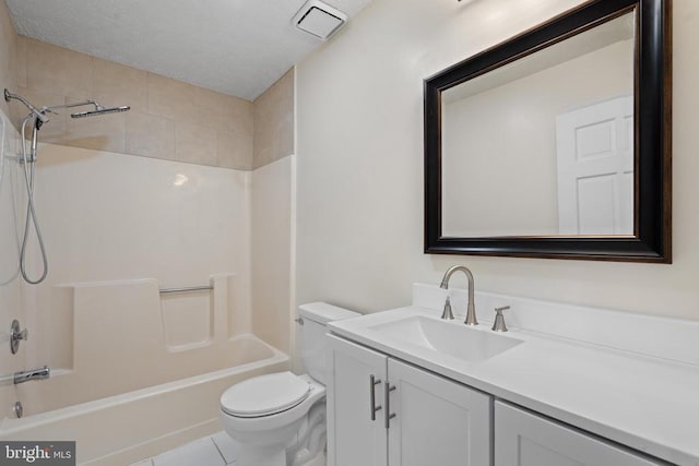 full bathroom featuring tile patterned flooring, vanity, toilet, and tiled shower / bath combo