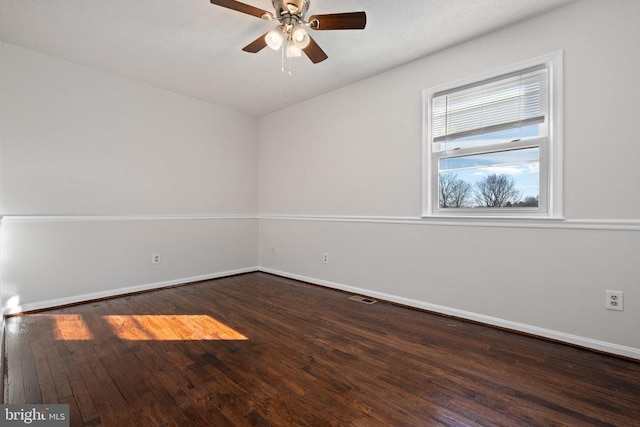 empty room with ceiling fan and dark wood-type flooring