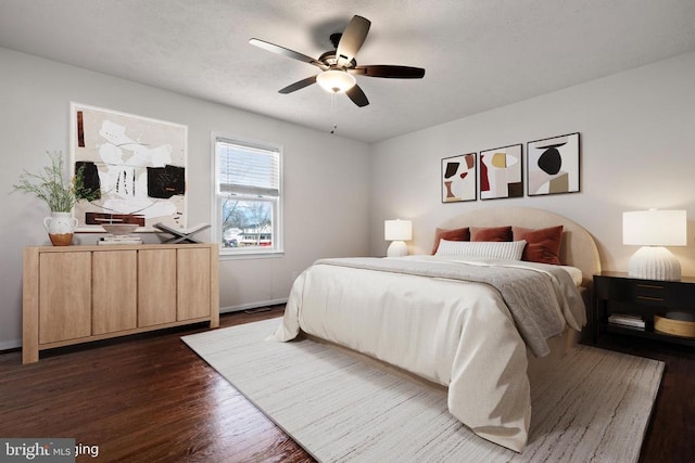 bedroom with ceiling fan, radiator heating unit, and dark hardwood / wood-style floors