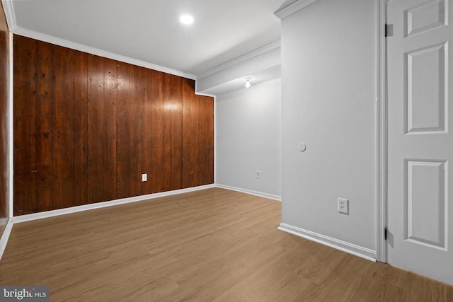 spare room with hardwood / wood-style floors and ornamental molding