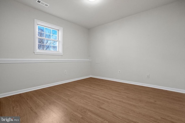 unfurnished room featuring hardwood / wood-style flooring