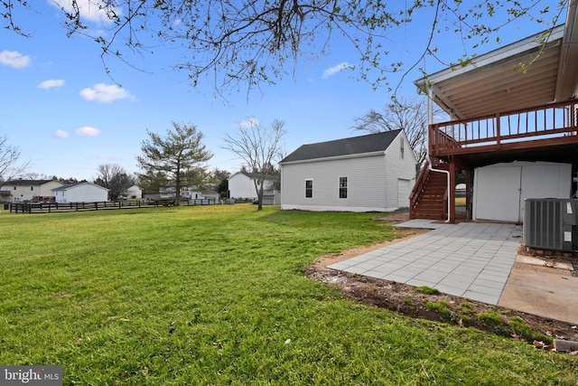 view of yard with central AC, a patio, an outdoor structure, and a deck