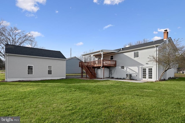 rear view of property with french doors, a yard, a deck, and central AC unit