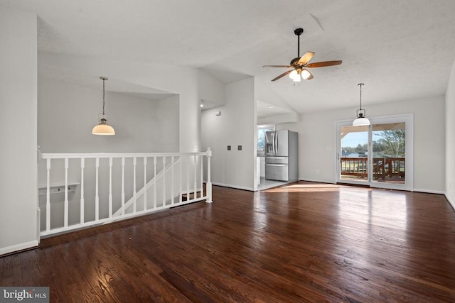 empty room featuring ceiling fan, dark hardwood / wood-style flooring, and vaulted ceiling