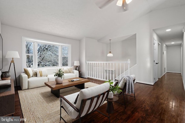 living room featuring ceiling fan, dark hardwood / wood-style floors, and lofted ceiling