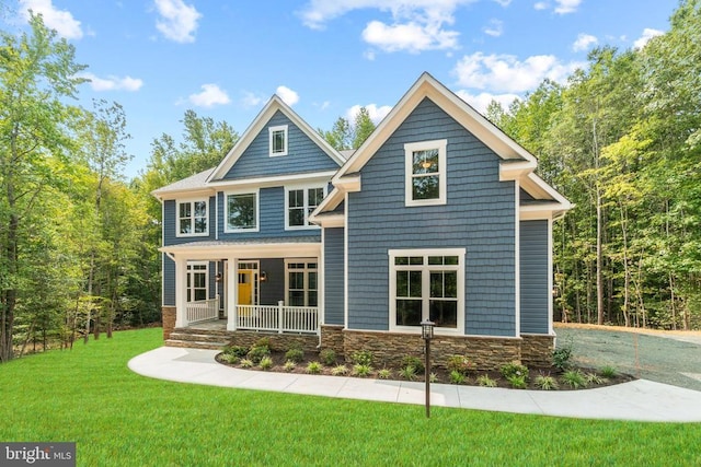 view of front of property with covered porch and a front lawn