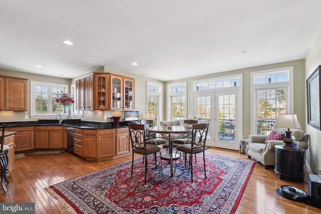 dining room with light wood-type flooring and sink