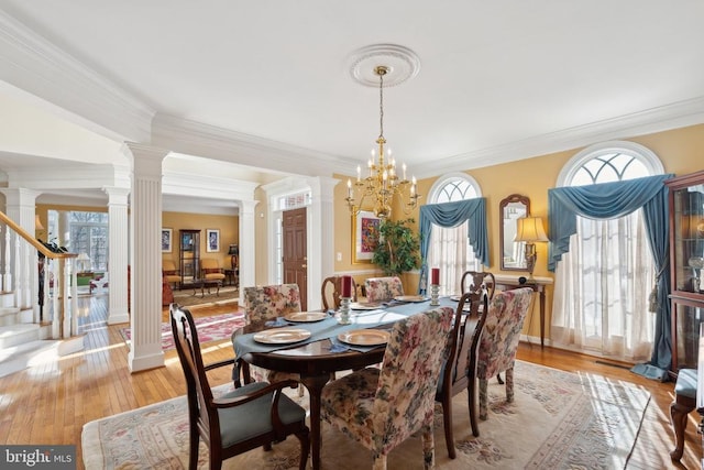 dining room featuring a notable chandelier, ornamental molding, and a wealth of natural light