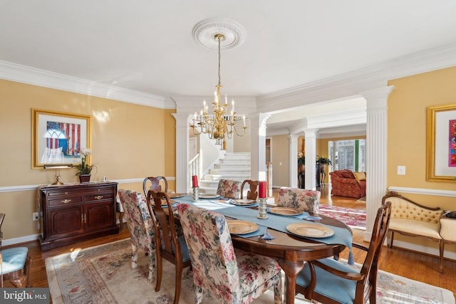 dining area featuring a chandelier, hardwood / wood-style flooring, and crown molding