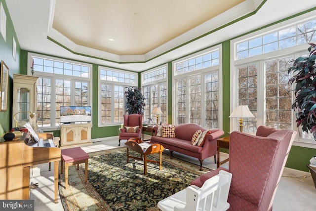 sunroom featuring a wealth of natural light and a tray ceiling