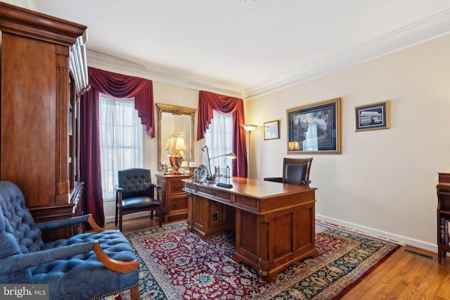 home office featuring crown molding and light wood-type flooring