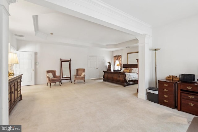 bedroom with light colored carpet, a raised ceiling, and ornate columns