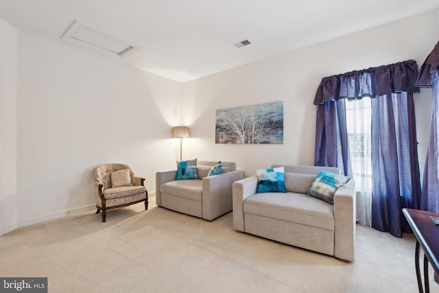 sitting room featuring light carpet