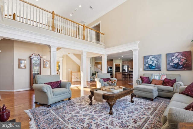 living room featuring a high ceiling and hardwood / wood-style floors