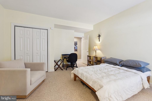 carpeted bedroom featuring a closet