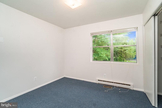 carpeted empty room with baseboard heating