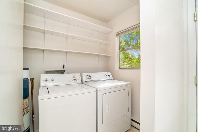 laundry area with independent washer and dryer and a baseboard radiator