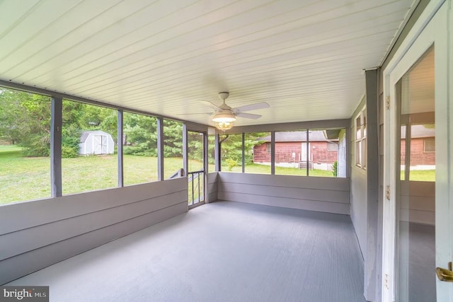 unfurnished sunroom featuring ceiling fan