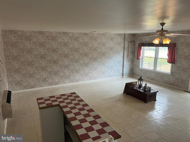 unfurnished living room with ceiling fan