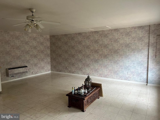 unfurnished room featuring heating unit and ceiling fan