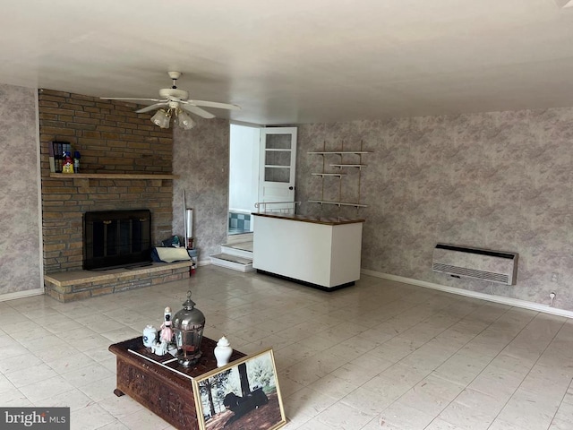 unfurnished living room featuring a fireplace and ceiling fan