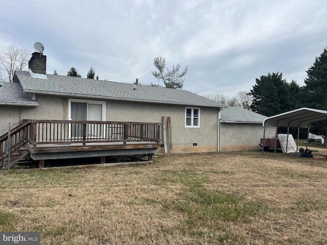 back of house with a yard, a deck, and a carport