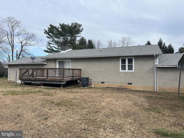 rear view of property featuring central AC, a lawn, and a wooden deck