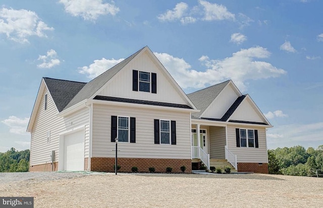 view of front of property featuring covered porch and a garage