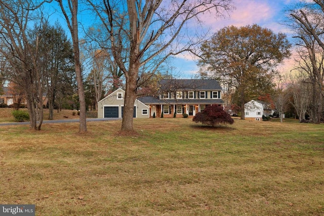 colonial house with a yard and an outdoor structure