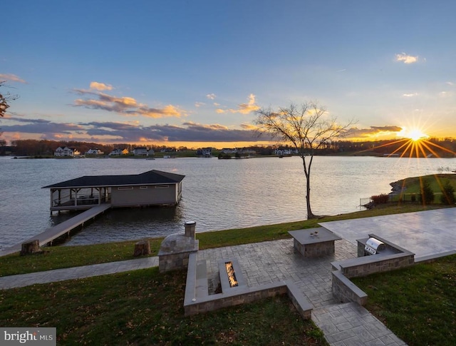 dock area featuring a patio area, a water view, and an outdoor fire pit