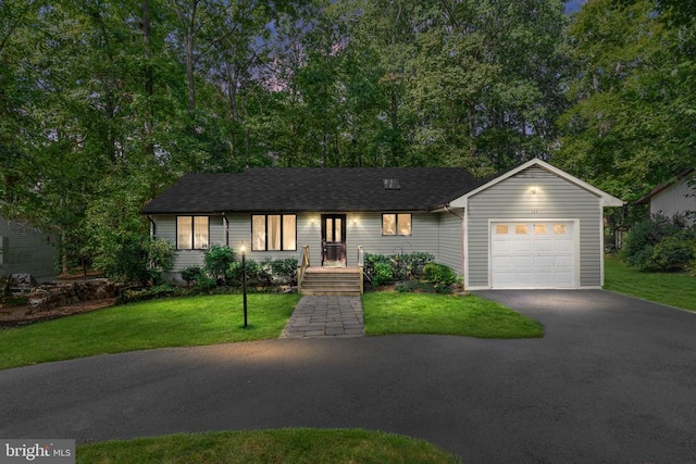 ranch-style house with a garage and a front yard