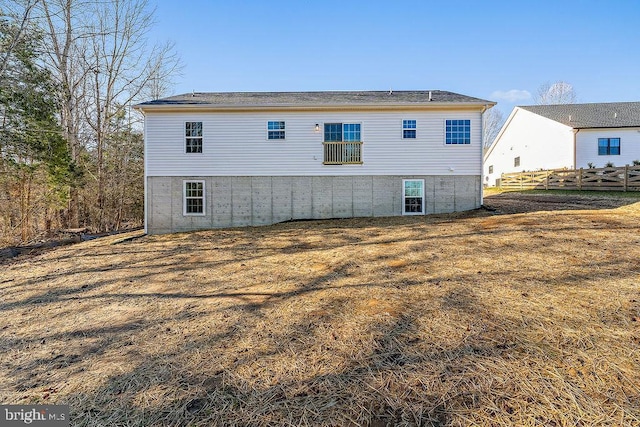 rear view of property featuring a lawn