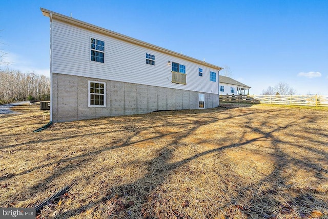 rear view of house featuring central AC