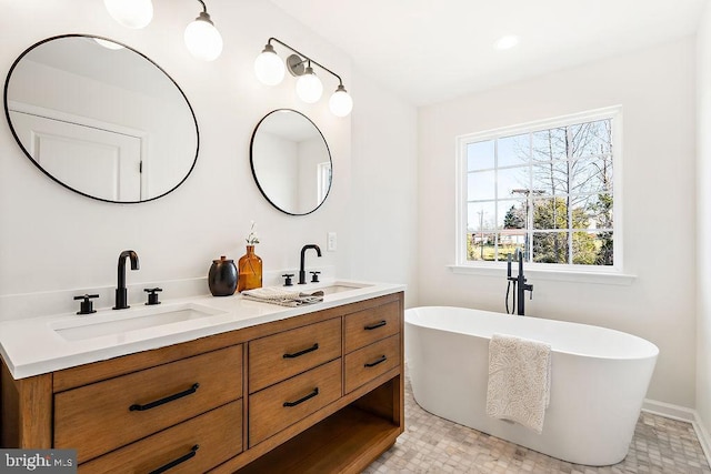 bathroom with vanity and a tub to relax in