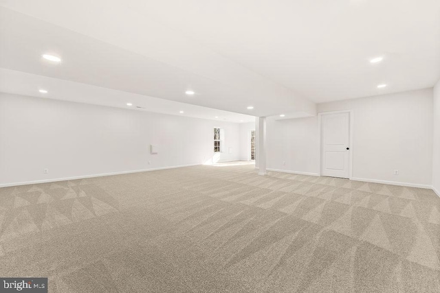 basement featuring light colored carpet