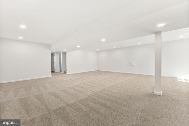 basement featuring light colored carpet