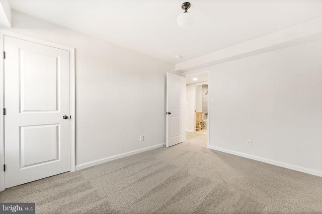 unfurnished room with light carpet