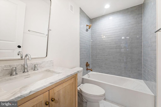 full bathroom with vanity, toilet, and tiled shower / bath