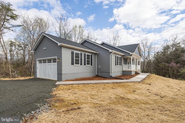 view of property exterior featuring a porch and a garage