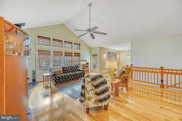 living room featuring ceiling fan, wood-type flooring, and high vaulted ceiling