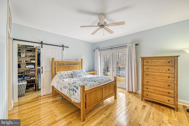 bedroom with ceiling fan, french doors, light hardwood / wood-style floors, access to outside, and a walk in closet