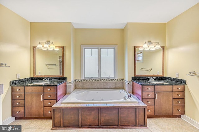 bathroom with tiled bath, tile patterned flooring, and vanity