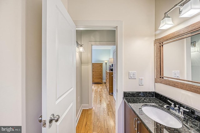 bathroom featuring vanity and hardwood / wood-style flooring