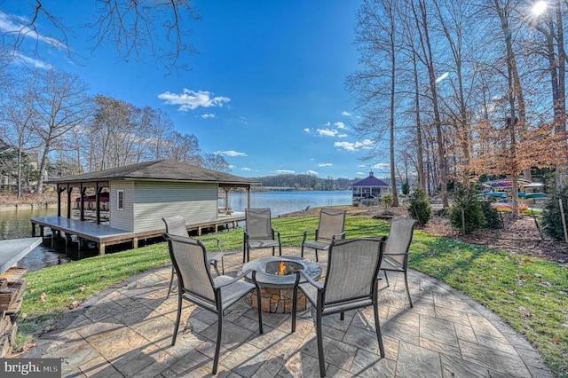 view of patio / terrace featuring a gazebo, a water view, and an outdoor fire pit