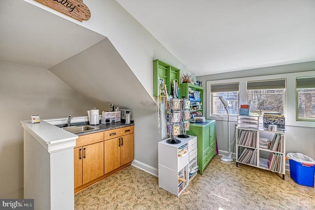 kitchen featuring lofted ceiling and sink